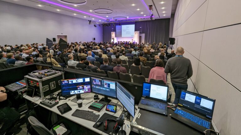 A live streaming control desk at the back of an event space